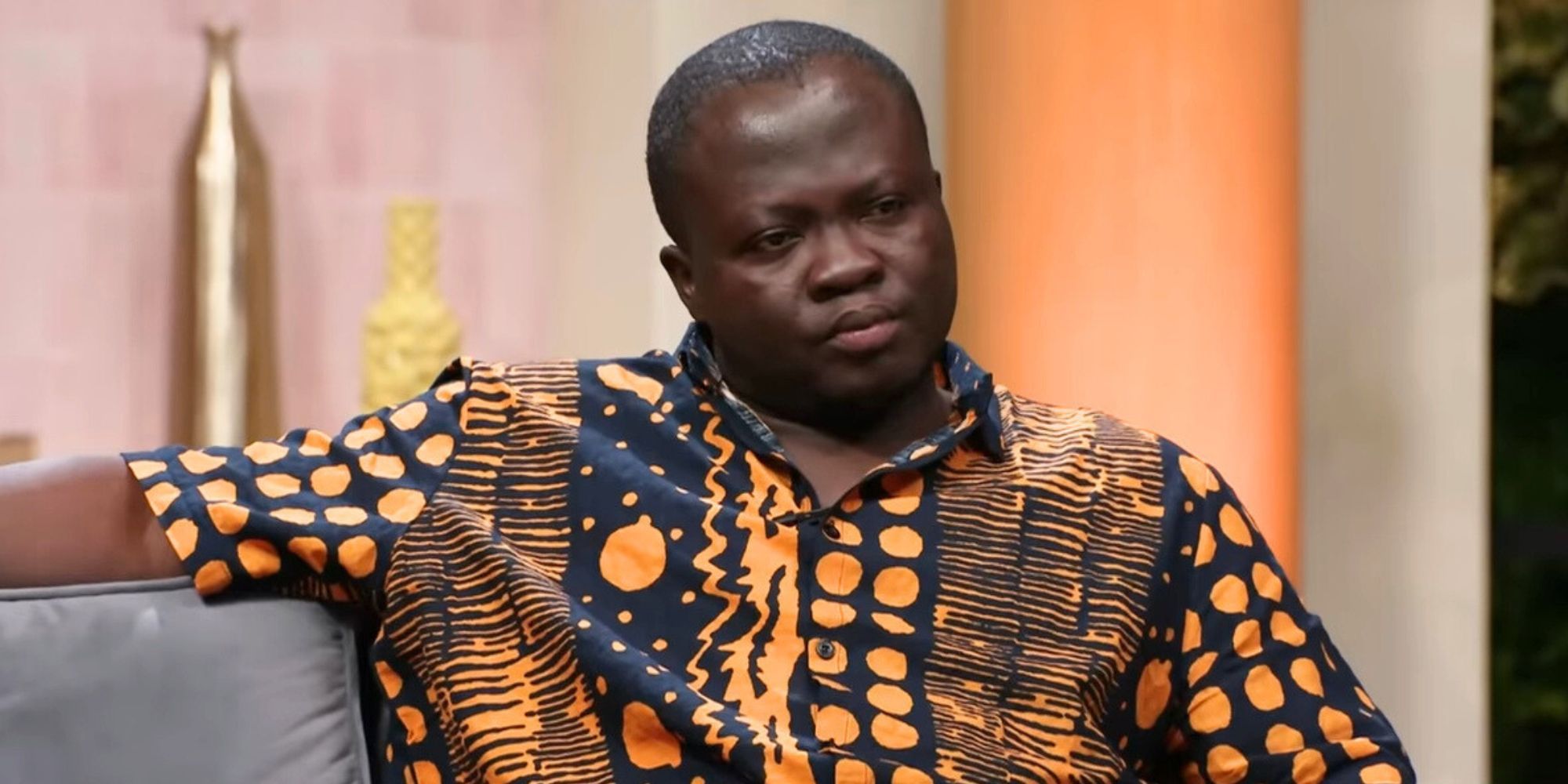 90 Day Fiance Michael Ilesanmi looking upset seated on a couch