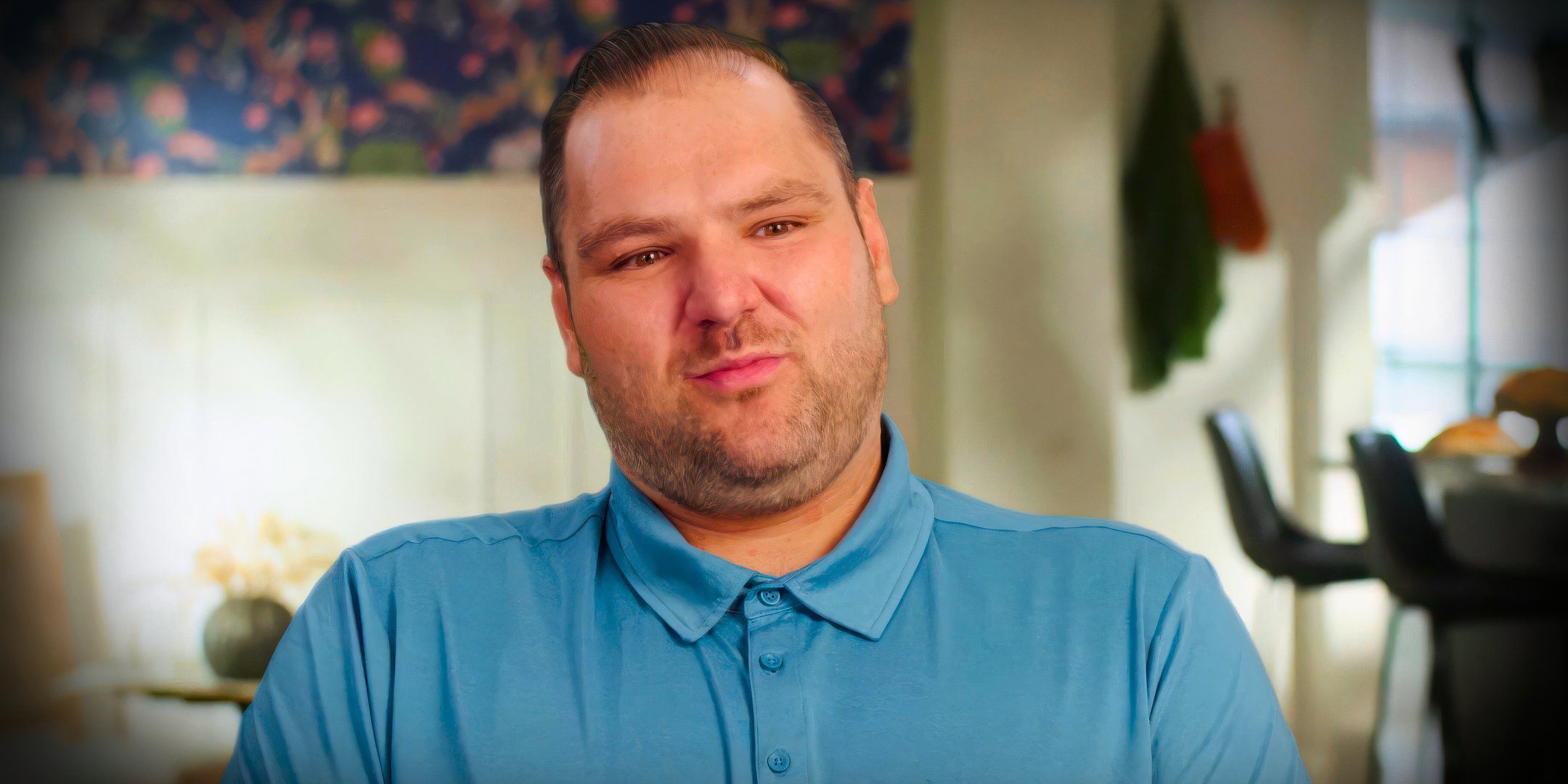 90 day fiance star greg chillak looking upset in a blue polo shirt
