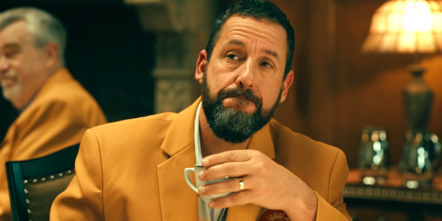 Adam Sandler holding a teacup in Happy Gilmore 2