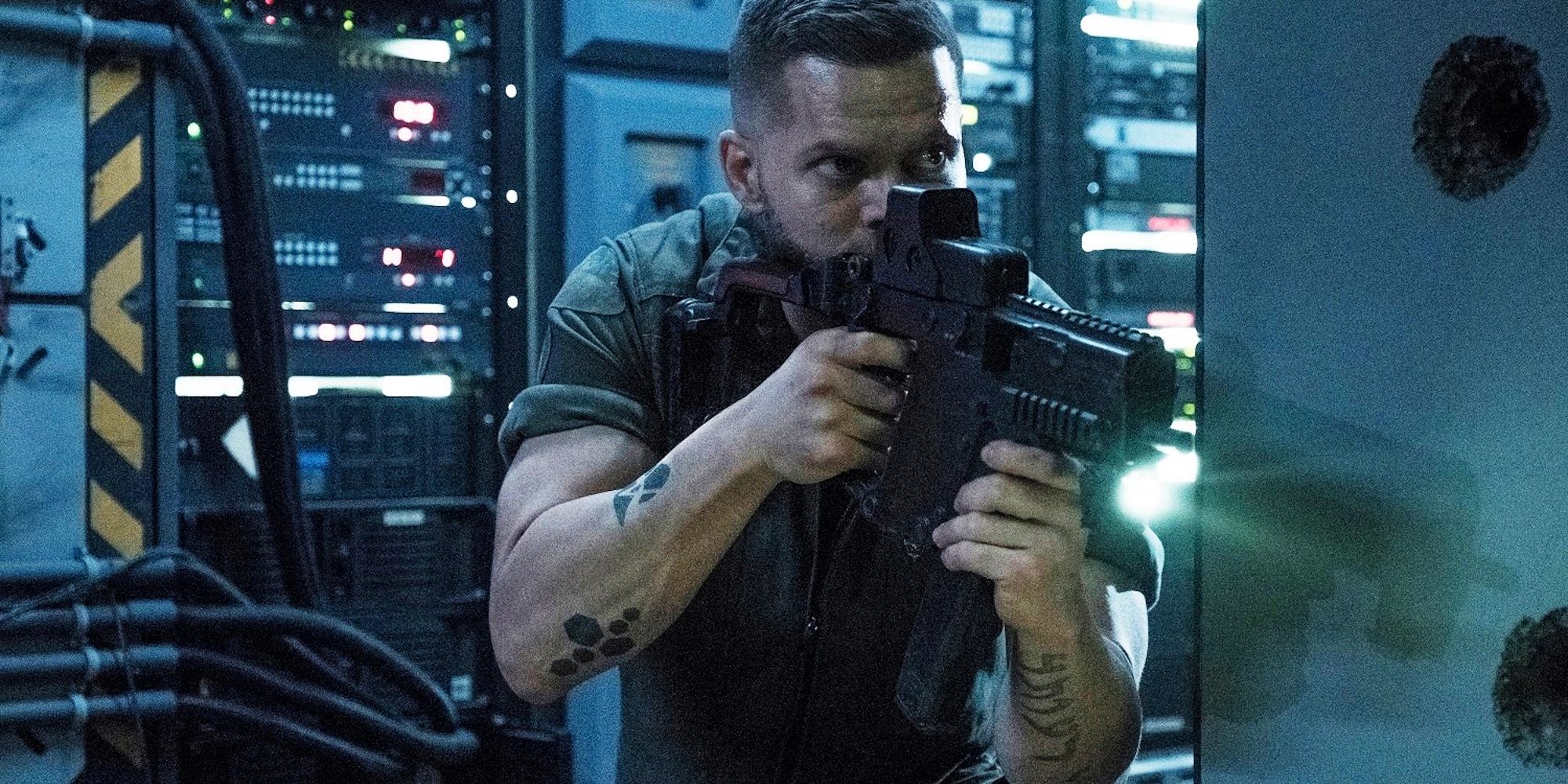 Amos Burton Holding A Gun in The Expanse