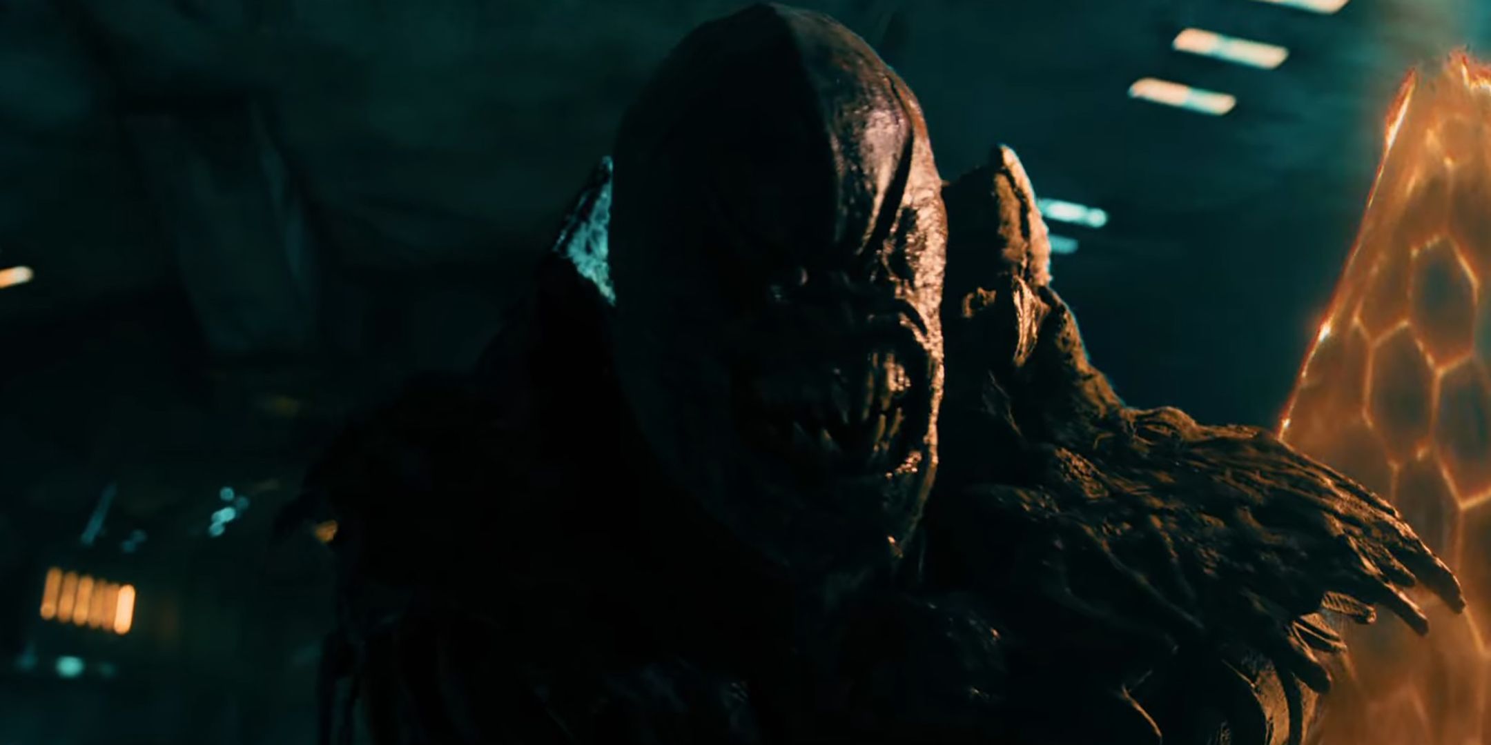 An alien looking menacingly towards the camera while holding his shield in Osiris