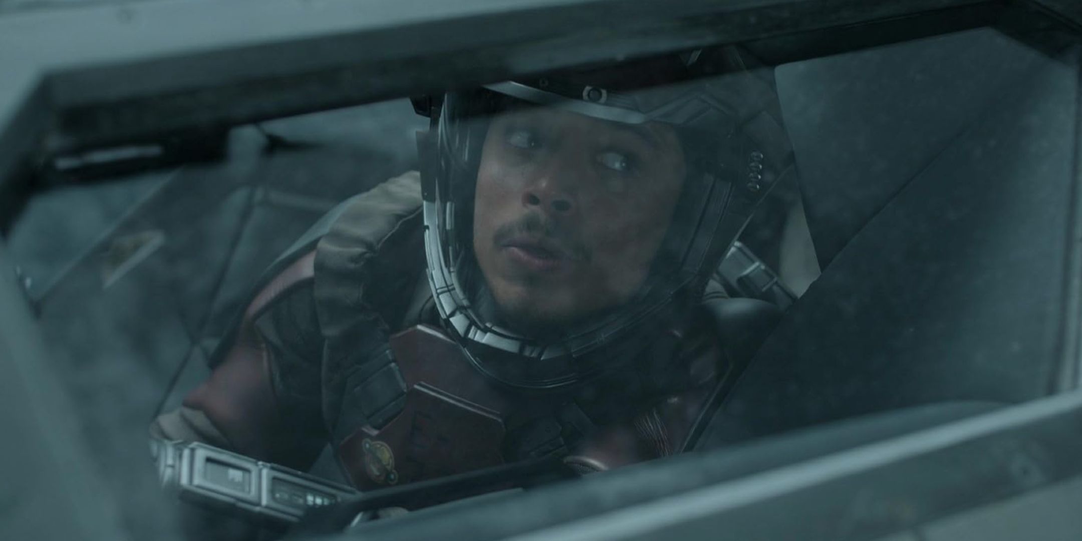 Anthony Ramos looking through a ship window as Andy in Long Distance