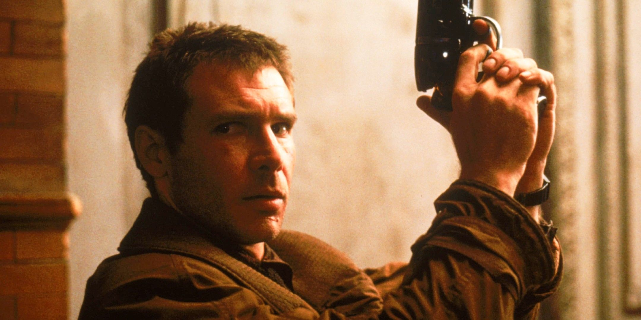 Deckard holds up his pistol while looking sideways in Blade Runner