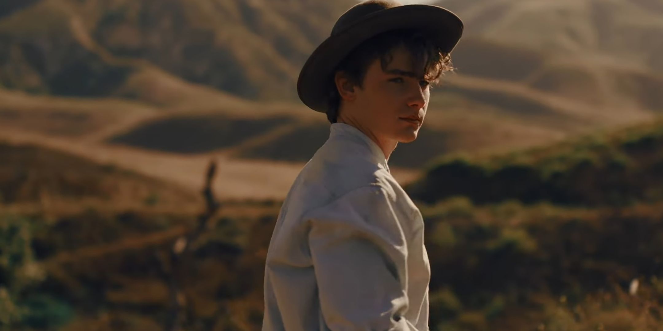 Brady Hepner's Max standing in a field in Abraham's Boys: A Dracula Story