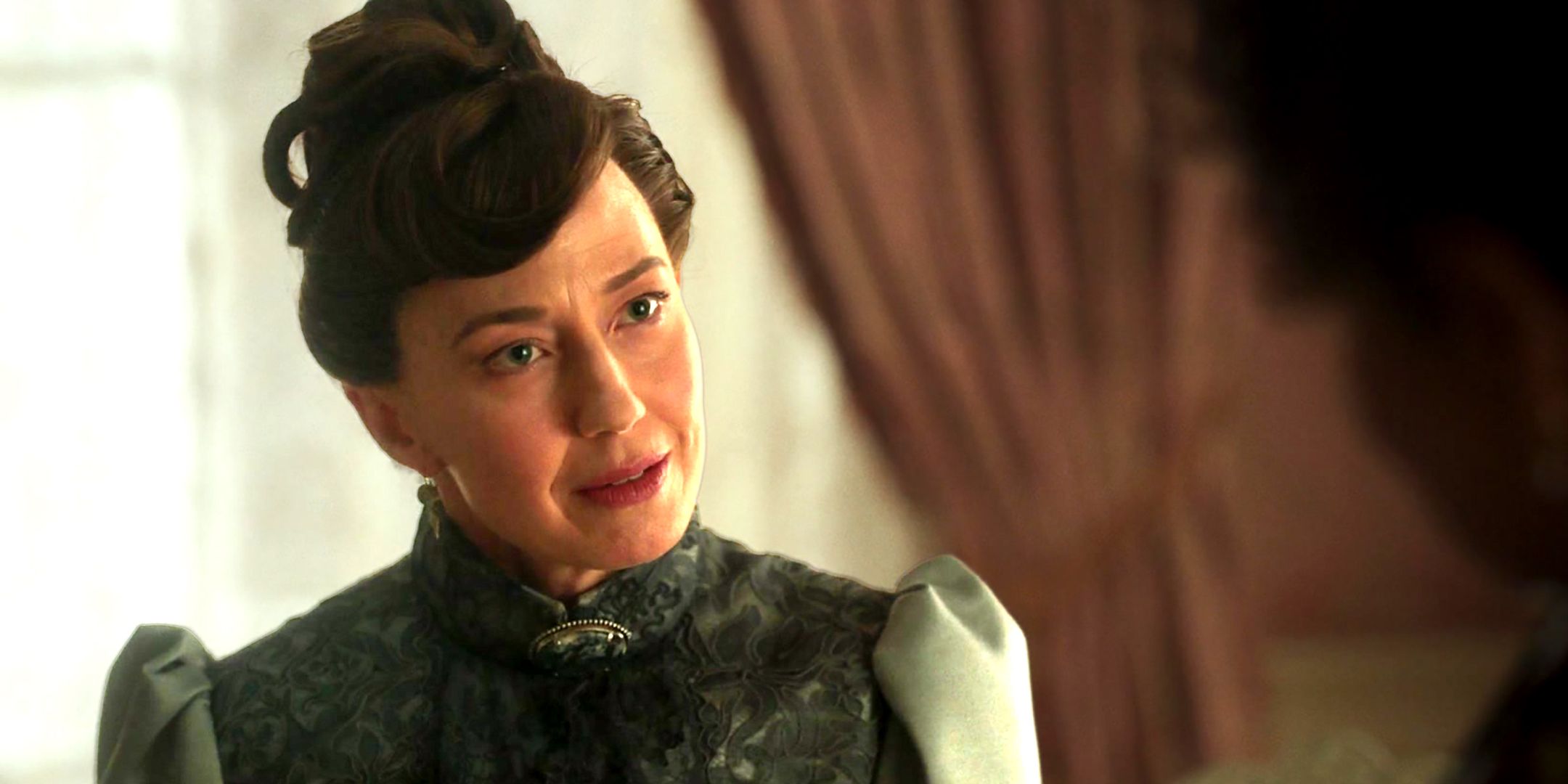Carrie Coon as Bertha looking curiously at someone in The Gilded Age season 3 episode 4