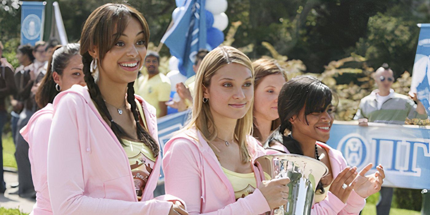 Casey, Ashley, and other ZBZ members don pink track suits and hold up their Greek Week trophy on Greek