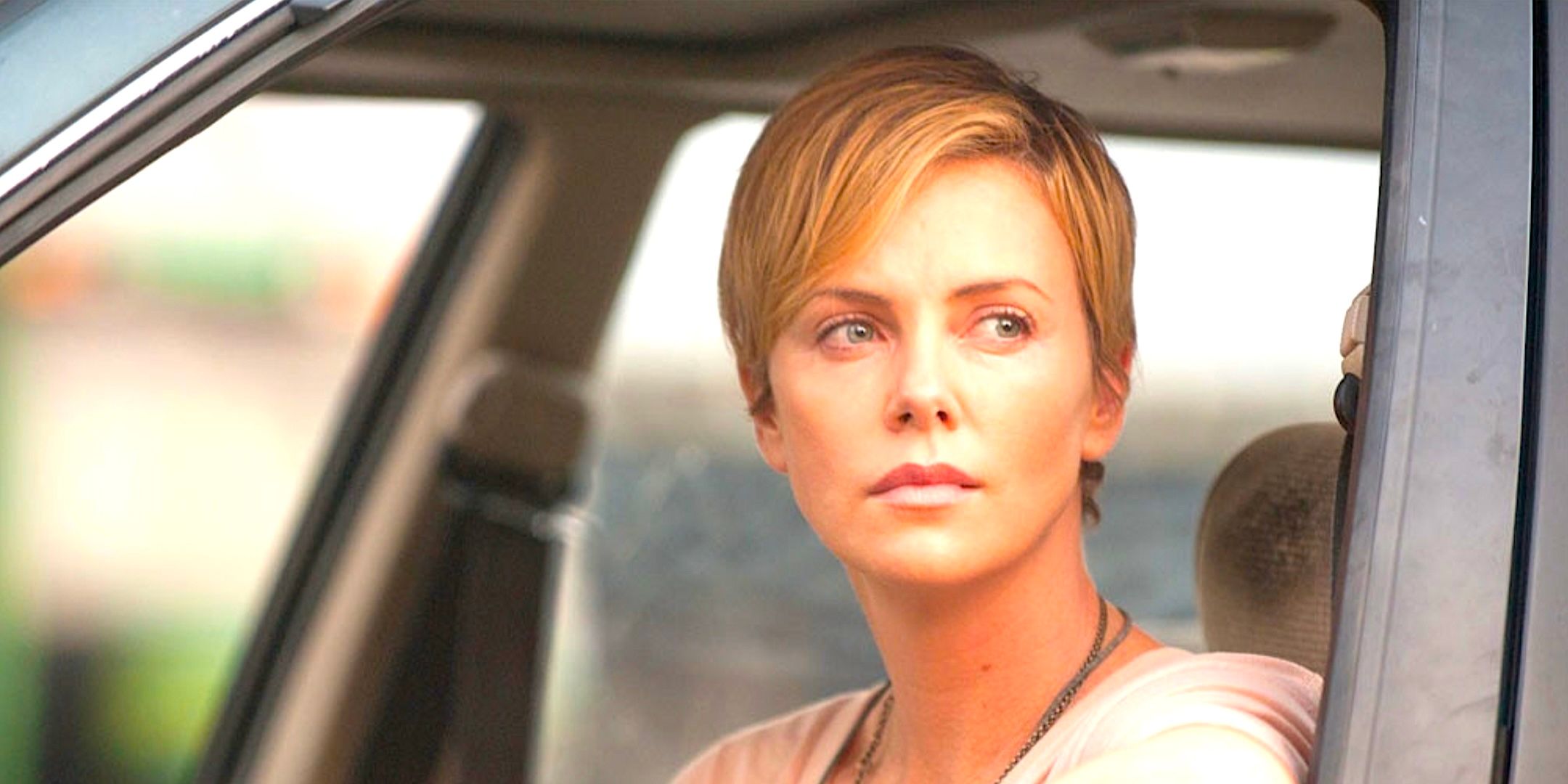 Charlize Theron's Libby looks out a car window in Dark Places 2015