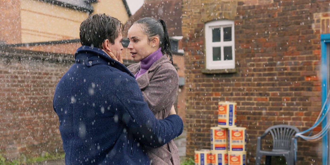 Corey Mylchreest and Sofia Carson embracing in the rain in My Oxford Year