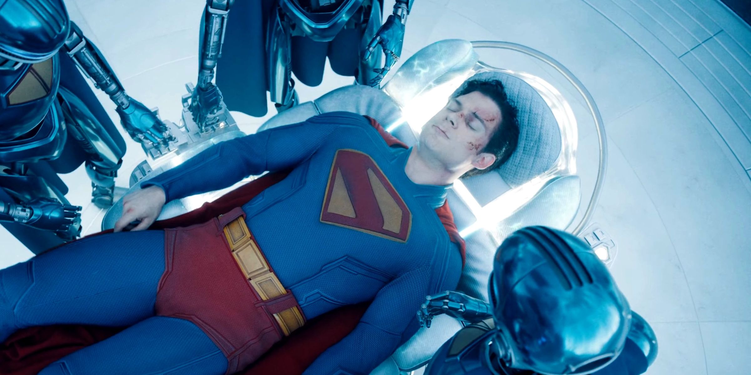 David Corenswet As Superman Laying In A Healing Chair Surrounded By Robots in Superman 2025
