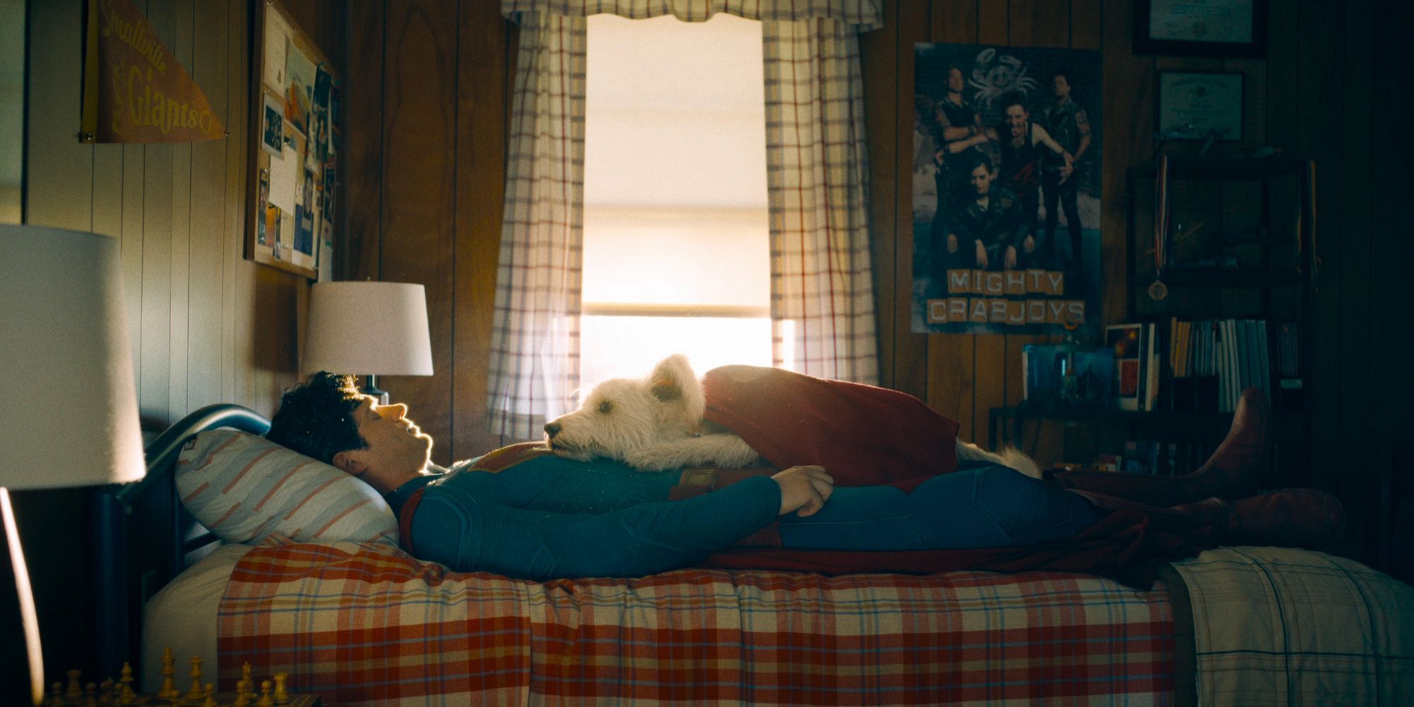 David Corenswet's Superman lies on his bed with Krypto on his chest in Superman (2025)