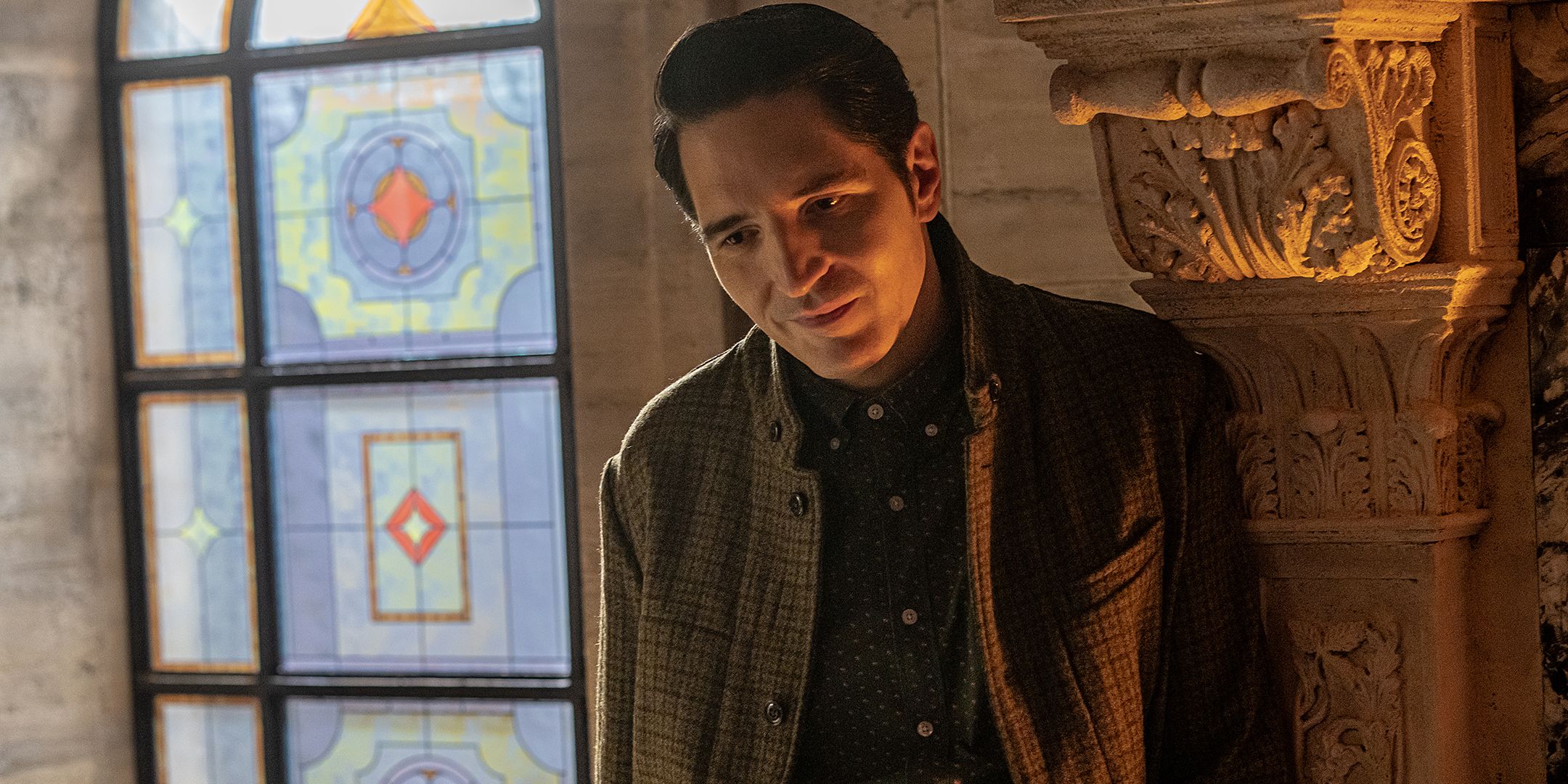 David Dastmalchian as Gemini smiling kindly while leaning against a fireplace in Dexter: Resurrection