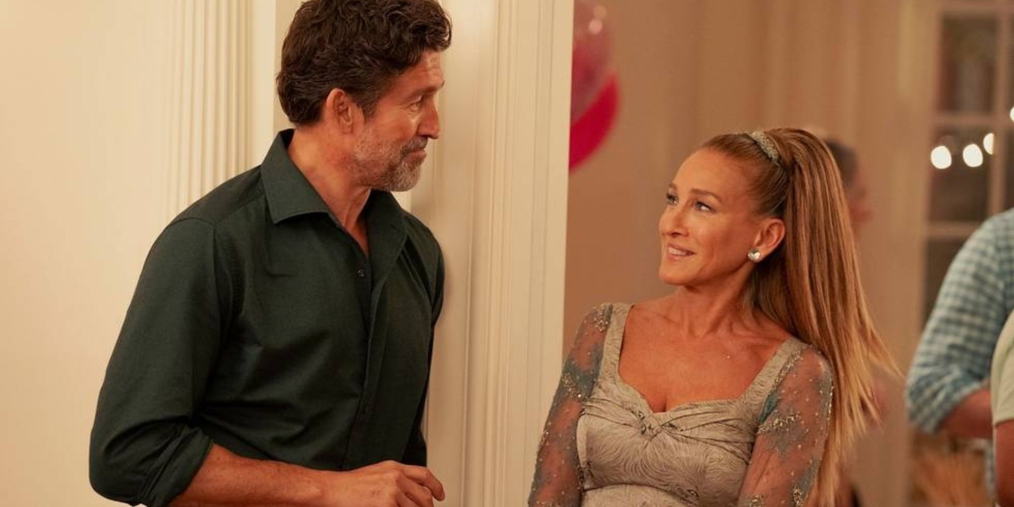 Duncan and Carrie smiling at each other at Charlotte's birthday party in And Just Like That season 3