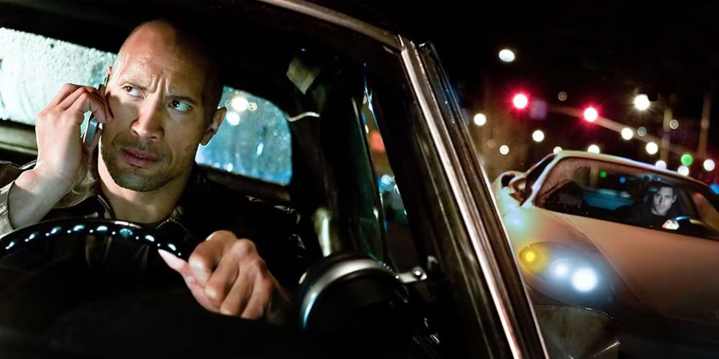 Dwayne Johnson on the phone, driving, and looking over his shoulder in Faster (2010)