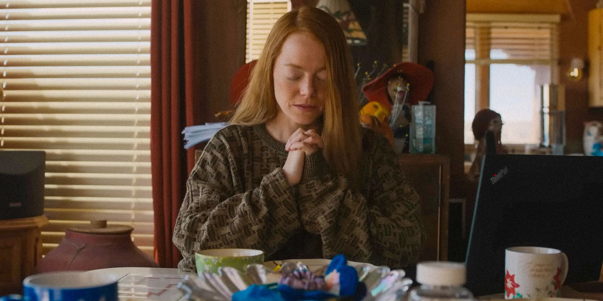 Louise Cross (Emma Stone) praying in Eddington
