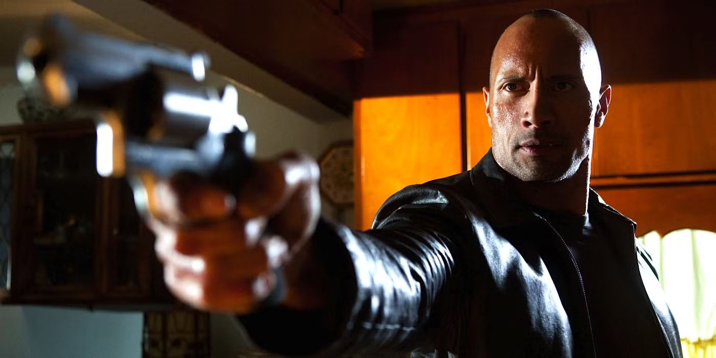Dwayne Johnson aiming a gun in Faster (2010)