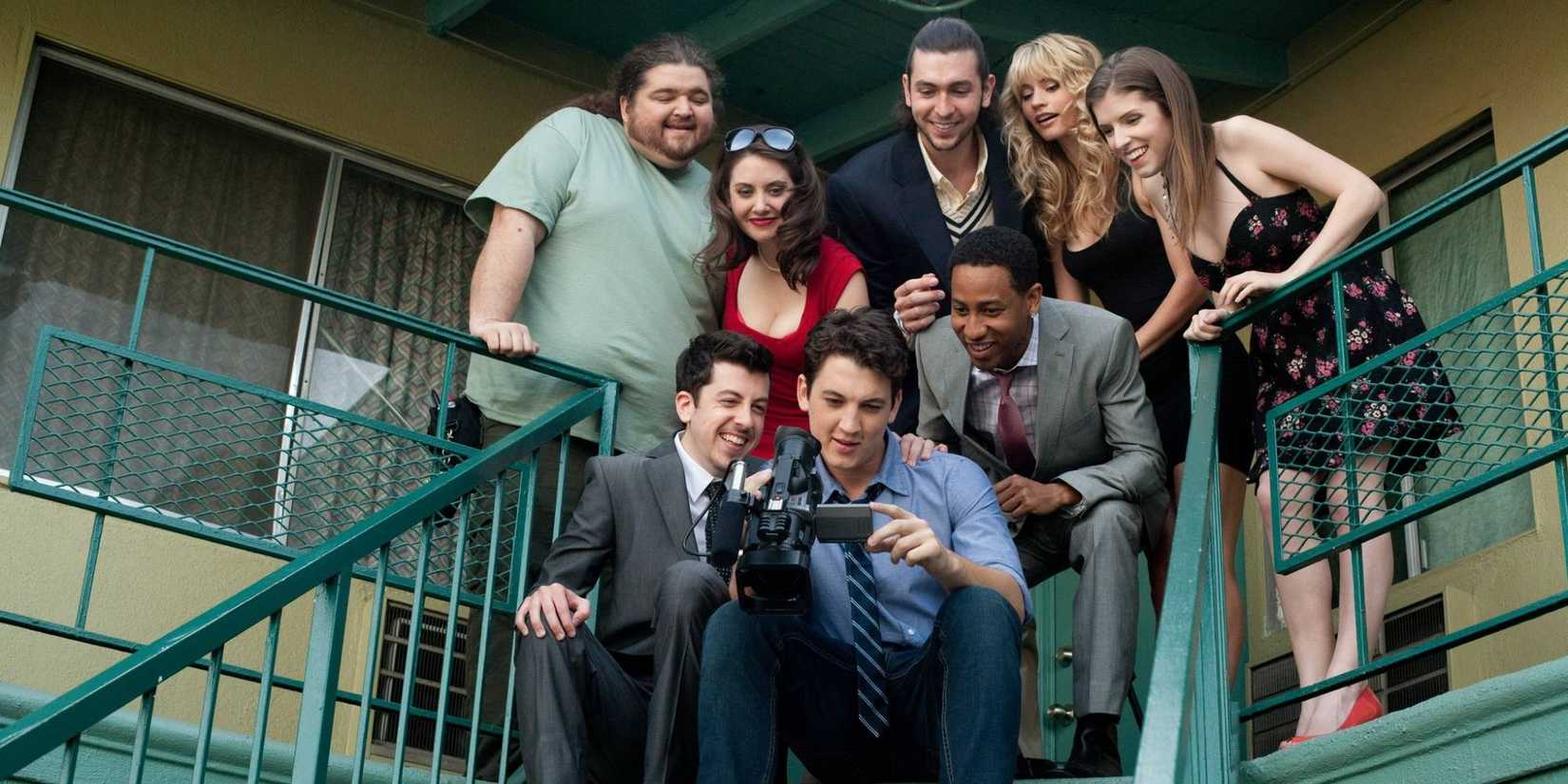 A group of friends pose for a picture while standing at the top of a staircase in a scene from Get a Job