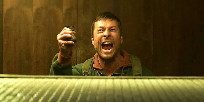 Glen Powell is yelling at someone walking towards him in The Running Man