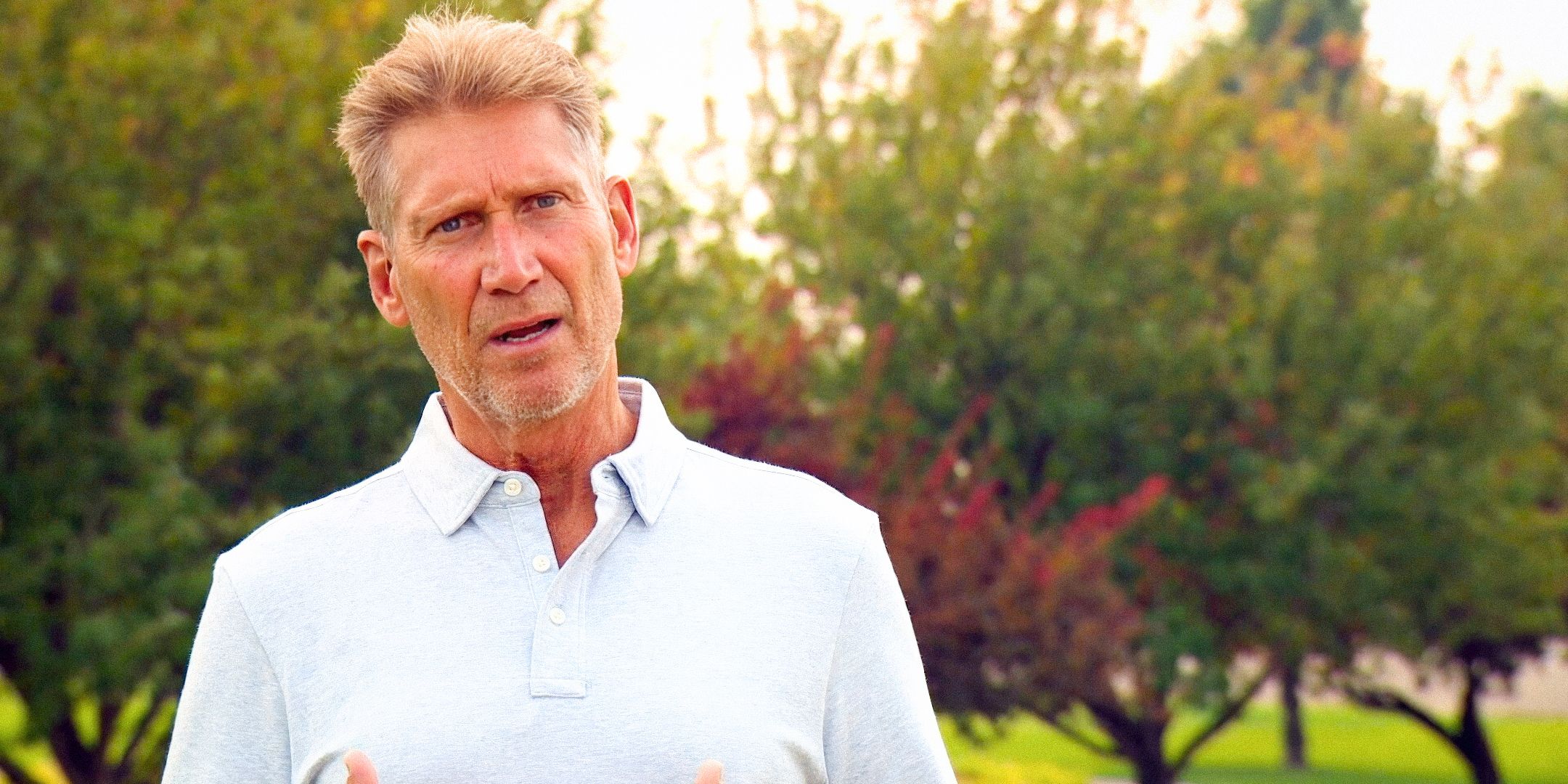 Golden Bachelor's Gerry Turner with a confused expression, with trees behind him