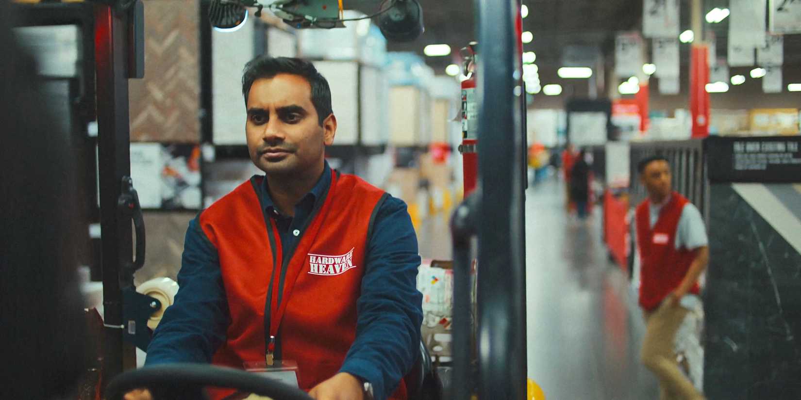 Aziz Ansari as Arj bored at work in Good Fortune