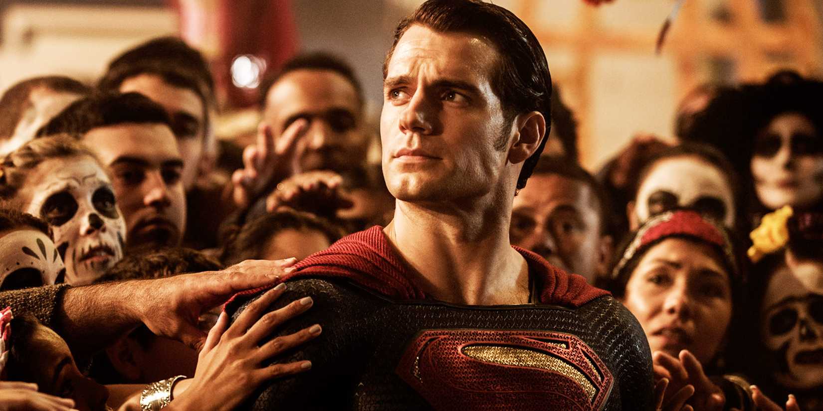 Henry Cavill as Superman in a crowd being touched.