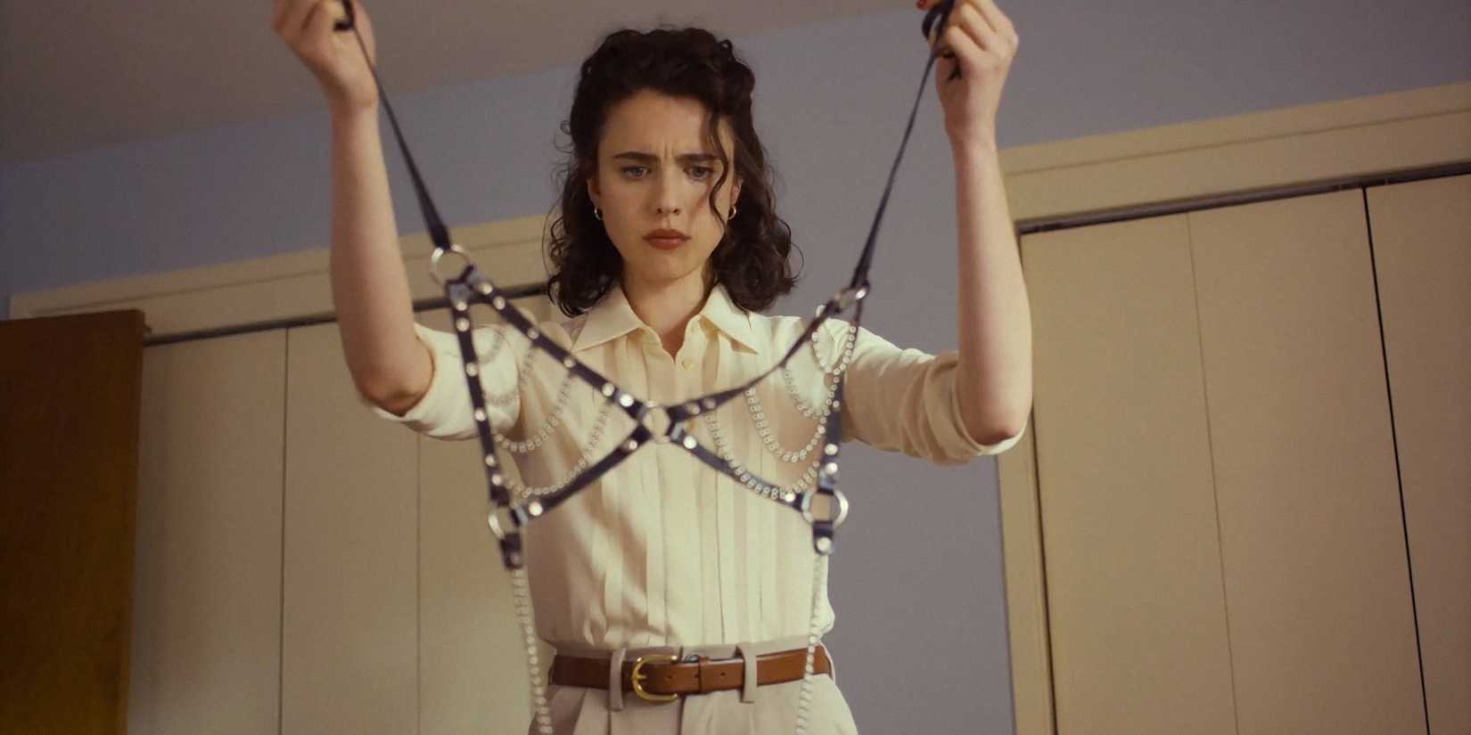 Honey O'Donahue (Margaret Qualley) looking at a harness bra in Honey Don't!