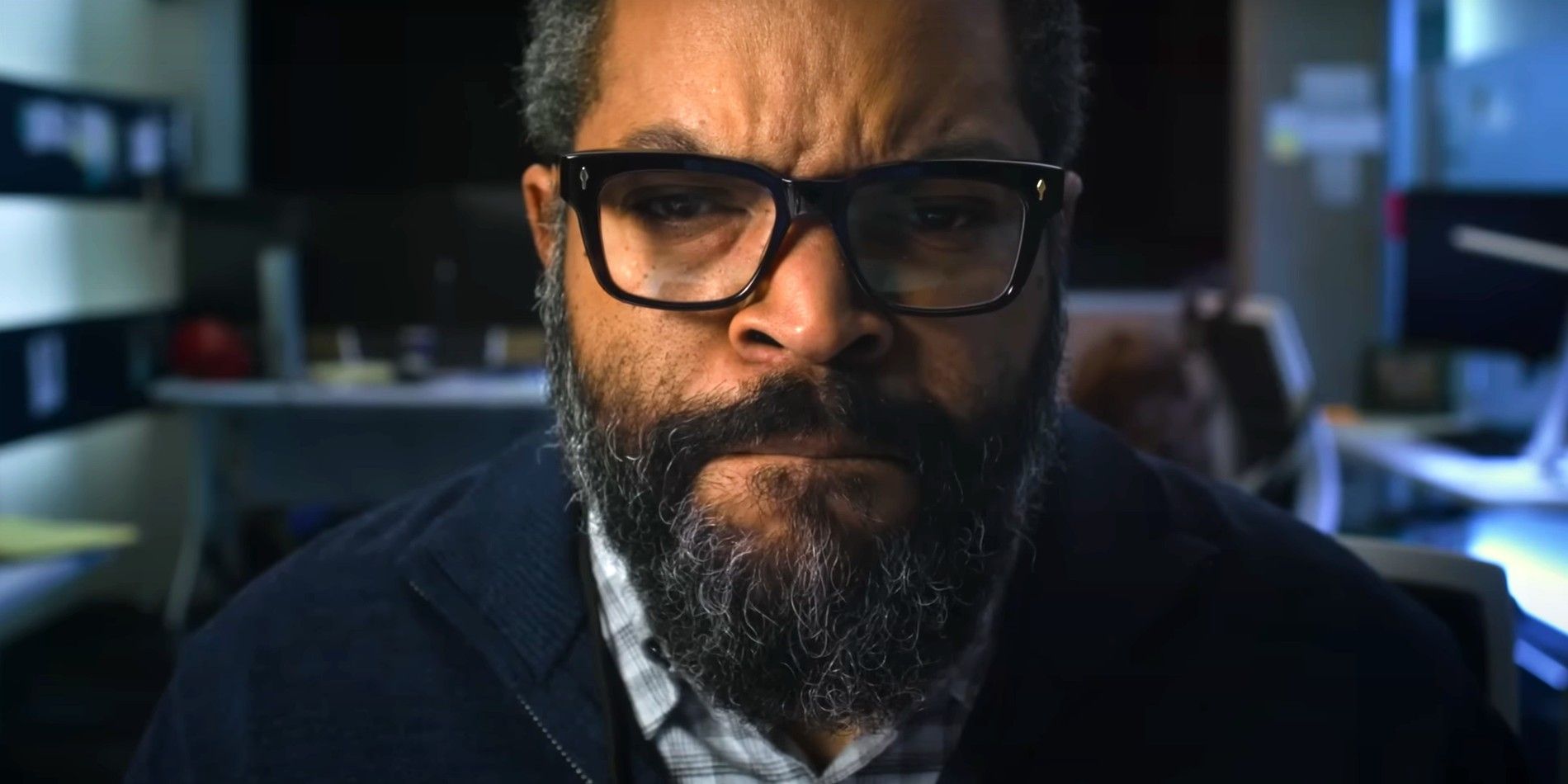Ice Cube is looking intensely at his computer in War of the Worlds 2025