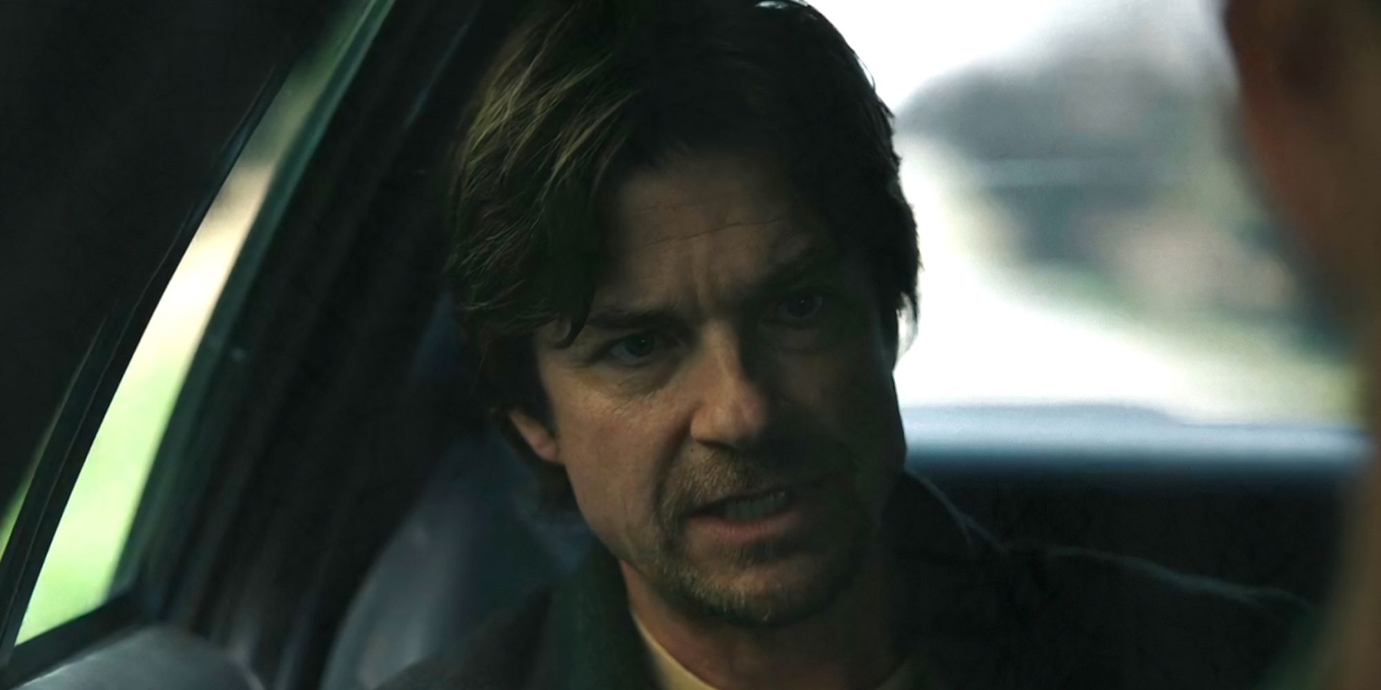 Jason Bateman as Terry Maitland speaking in the back of a police car in The Outsider Episode 1
