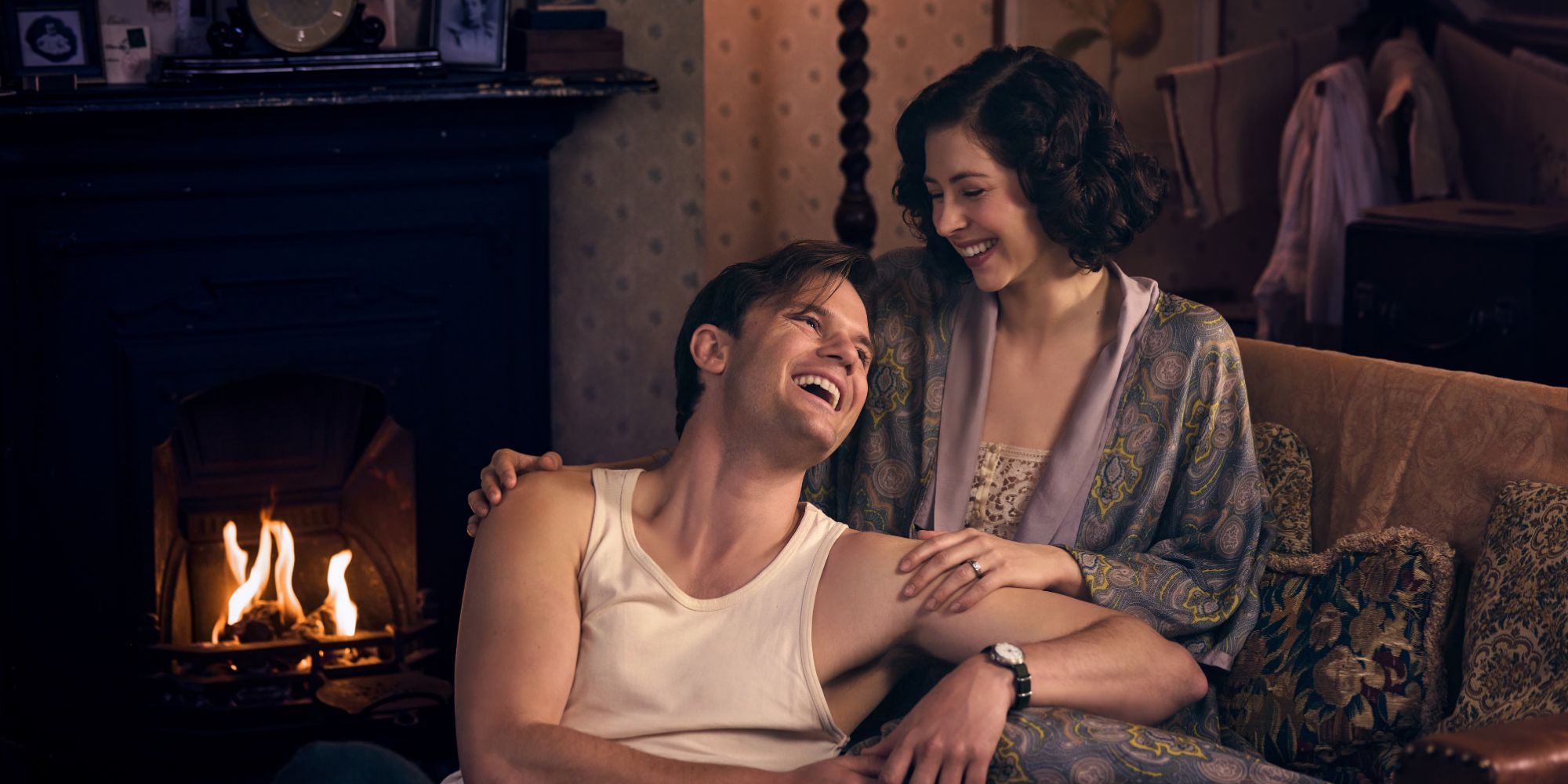 Jeremy Irvine (Henry Beauchamp) and Hermione Corfield (Julia Moriston) laughing together in Outlander Blood of My Blood. (1)