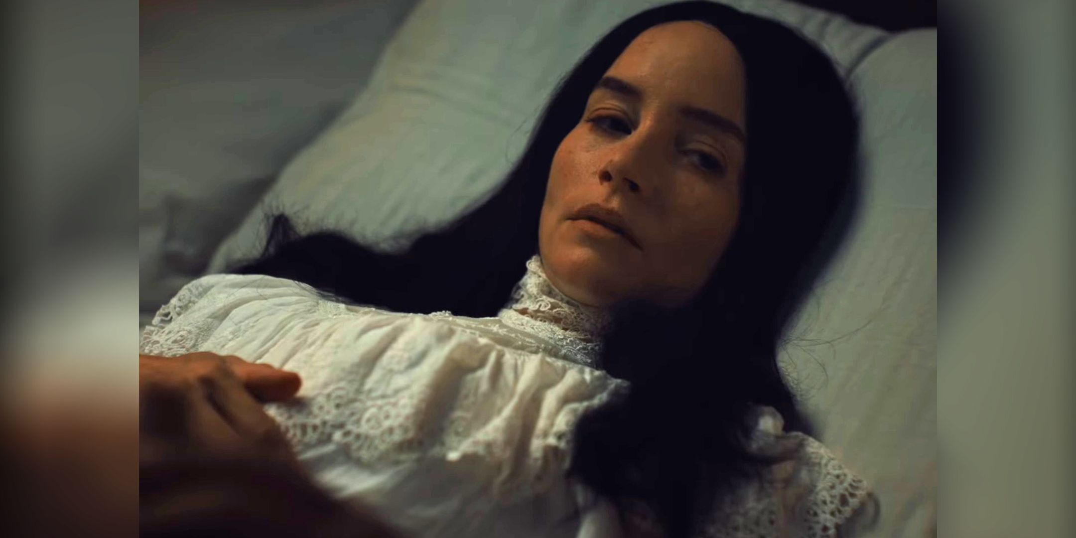 Jocelin Donahue as Mina laying in bed looking worried in Abraham's Boys: A Dracula Story