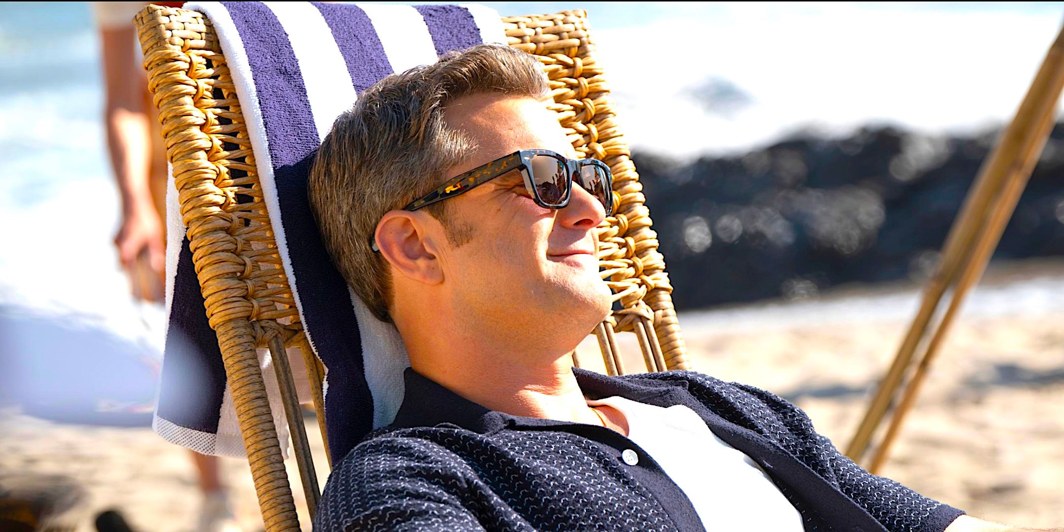 Joshua Jackson's Max lounges in the sun on a beach from Doctor Odyssey