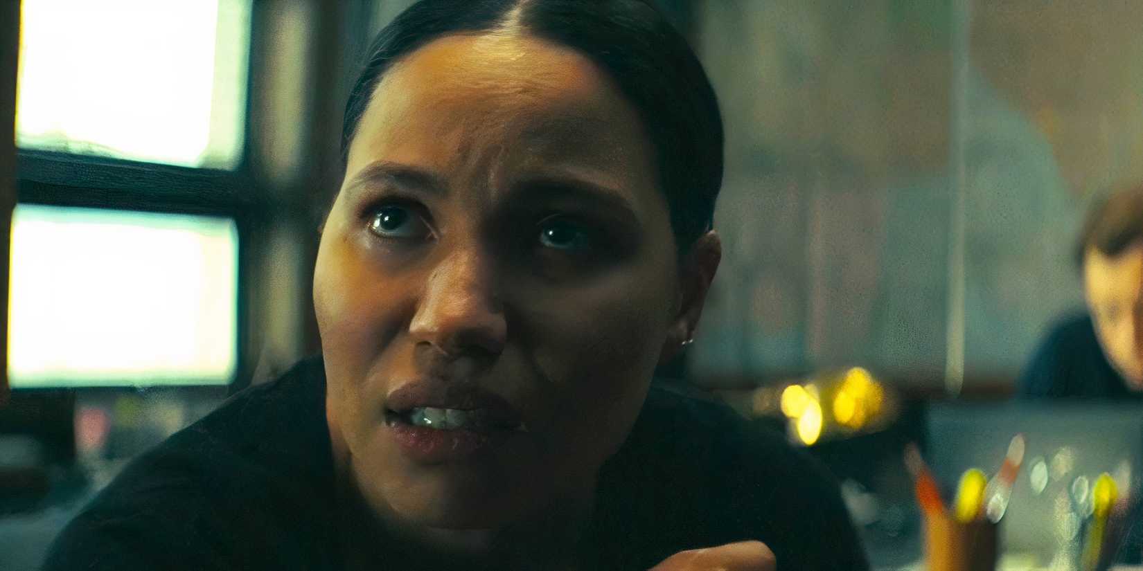 Jurnee Smollett as Michelle looking up at a suspect board pondering in Smoke episode 2