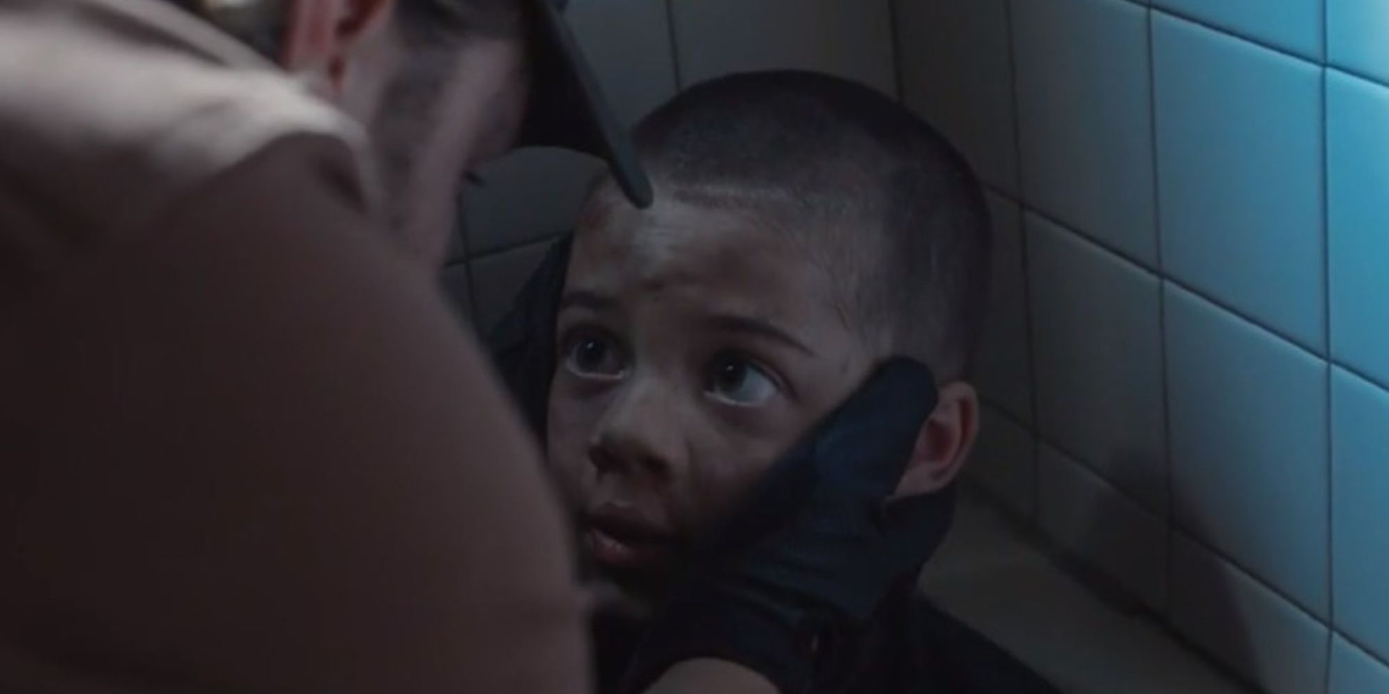 Kayce finding a terrified Tate with his head shaved in a bathtub in Yellowstone season 2