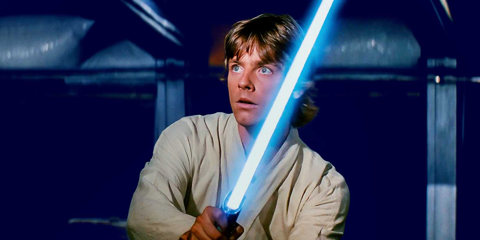 Luke Skywalker holding a blue lightsaber in Star Wars