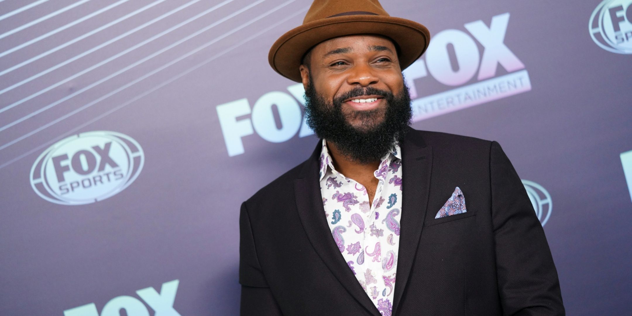 Malcolm-Jamal Warner smiling at a FOX event