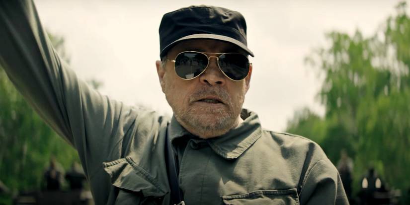 Mark Hamill with his arm in the air as the Major in The Long Walk