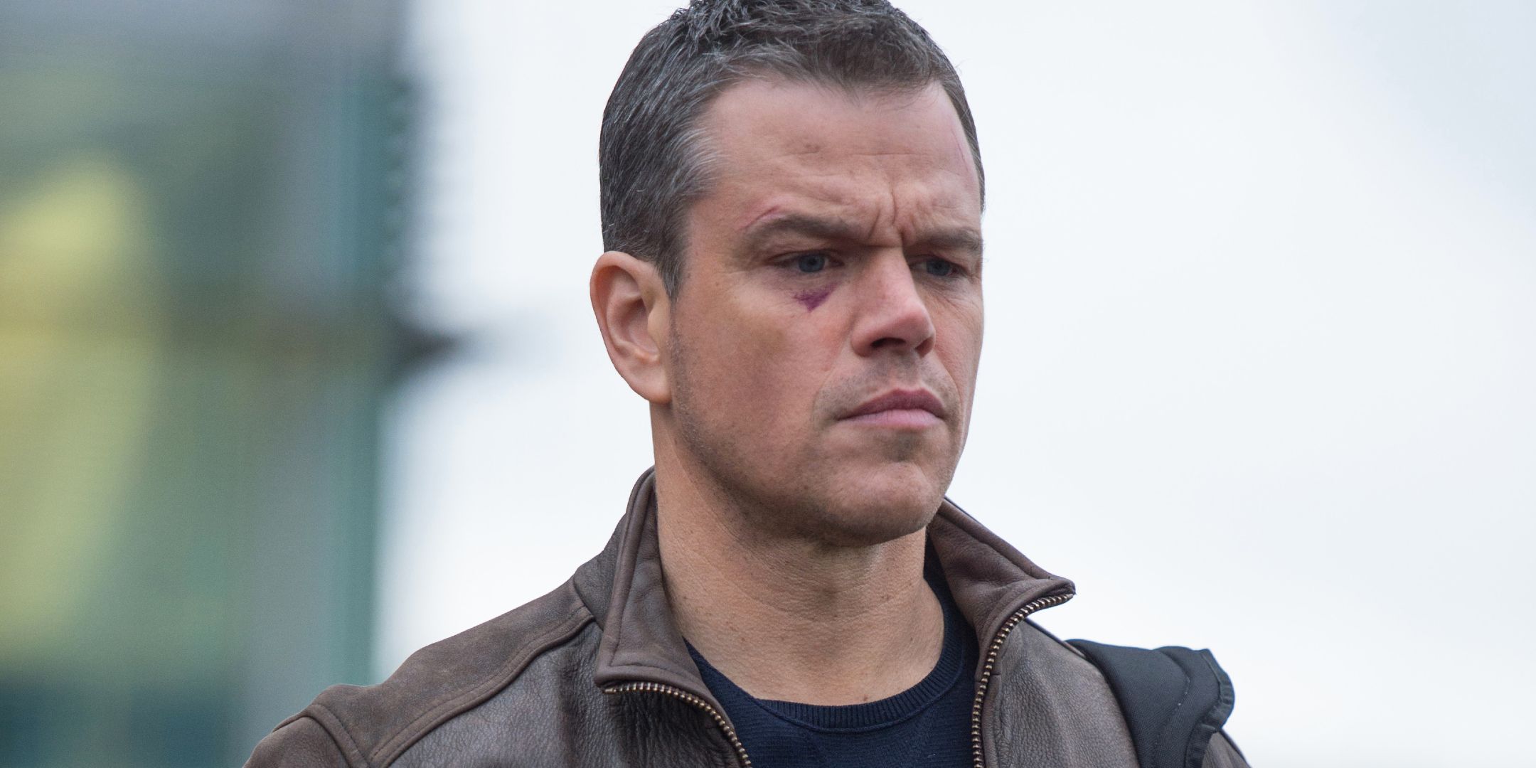 Matt Damon looking stern with a black eye and bruises in Jason Bourne