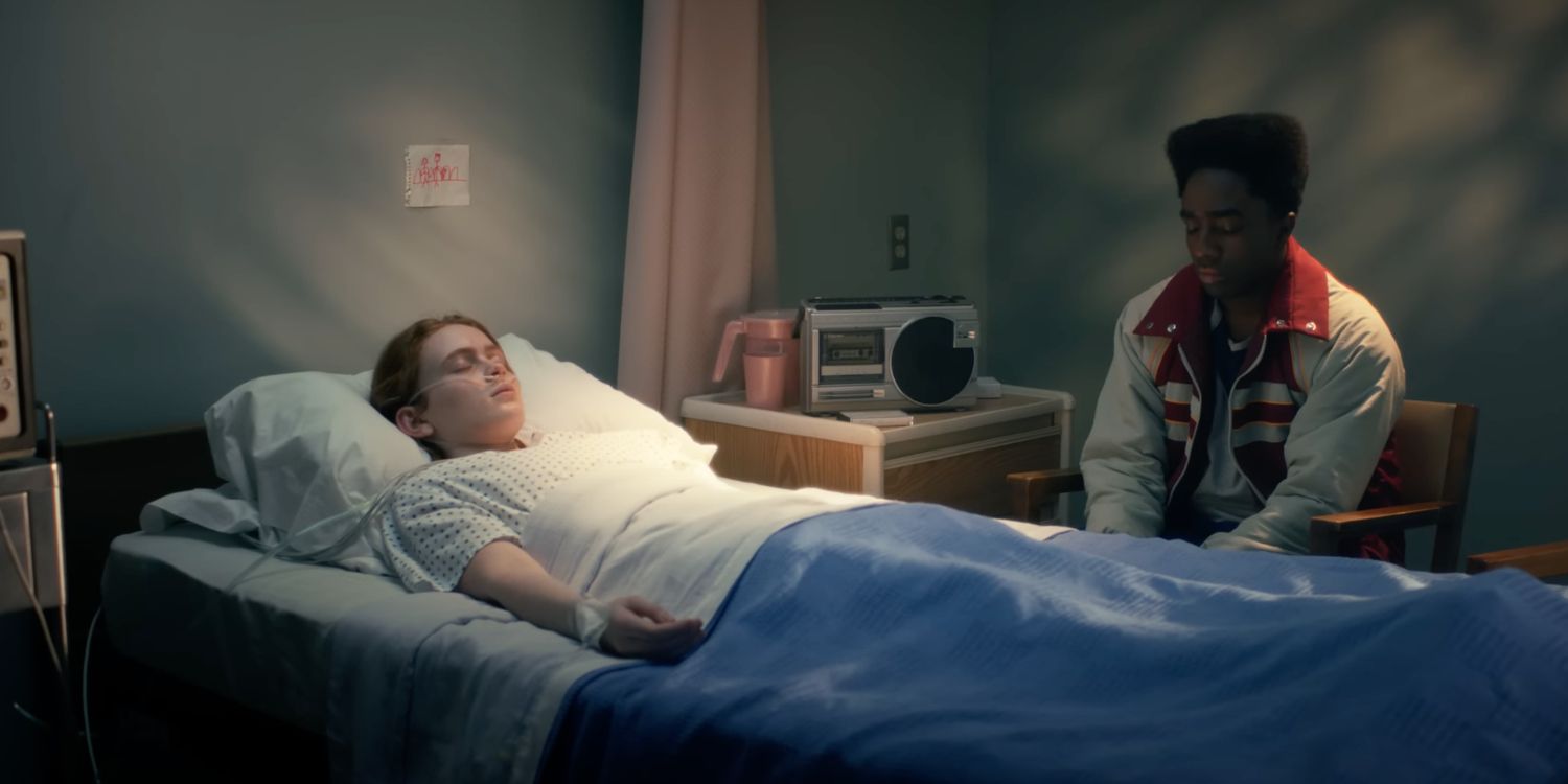 Max in a hospital bed with Lucas sitting beside her in Stranger Things season 5