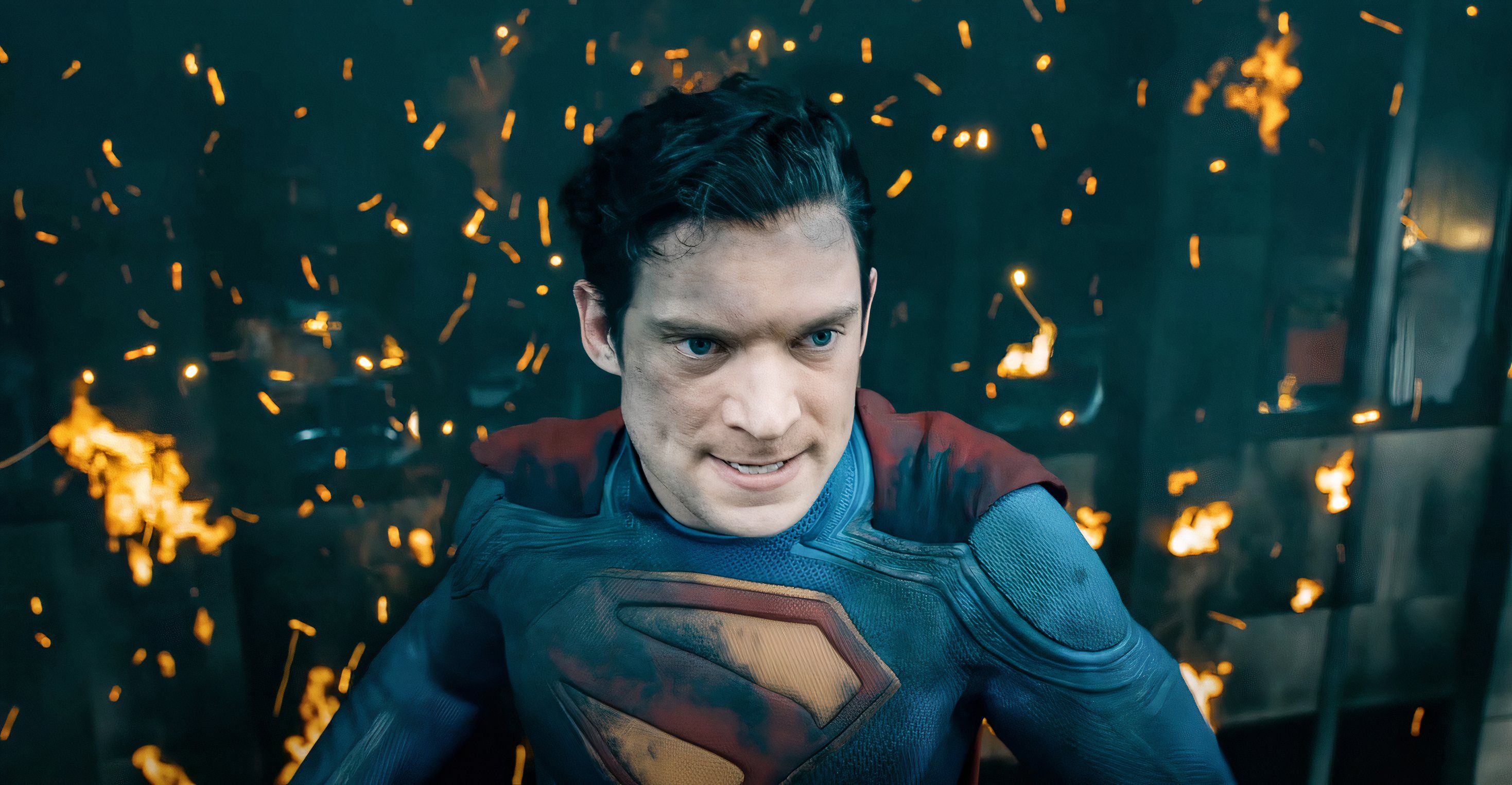 Superman grimacing, surrounded in flames and embers in 2025's Superman