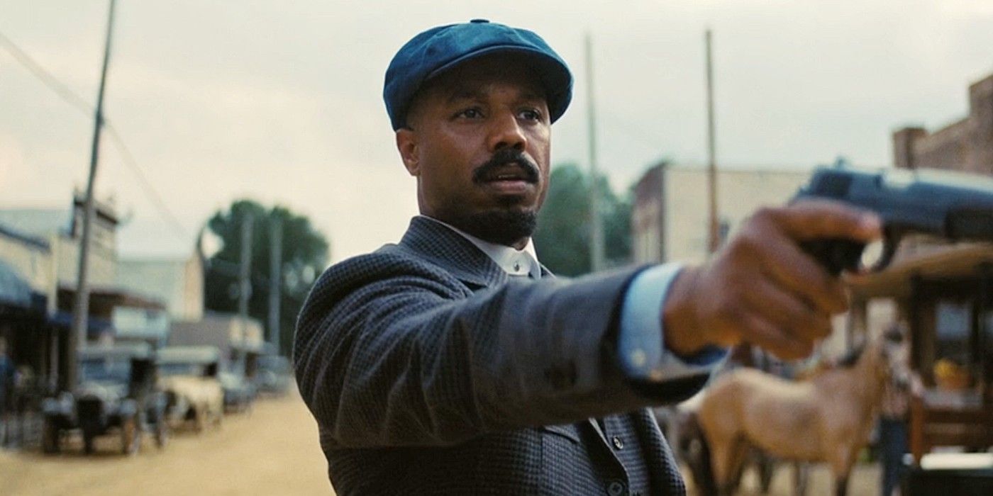 Michael B. Jordan aiming his gun at someone in Sinners