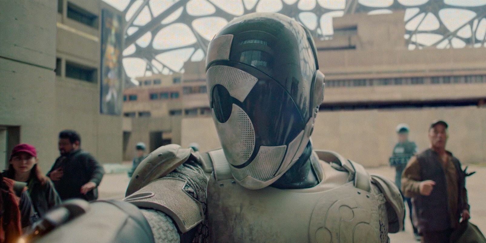 Alexander Skarsgård as Murderbot in a suit, preparing to fight