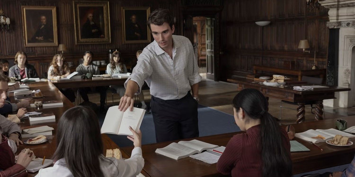 Jamie holds out a book to Anna in a classroom in My Oxford Year