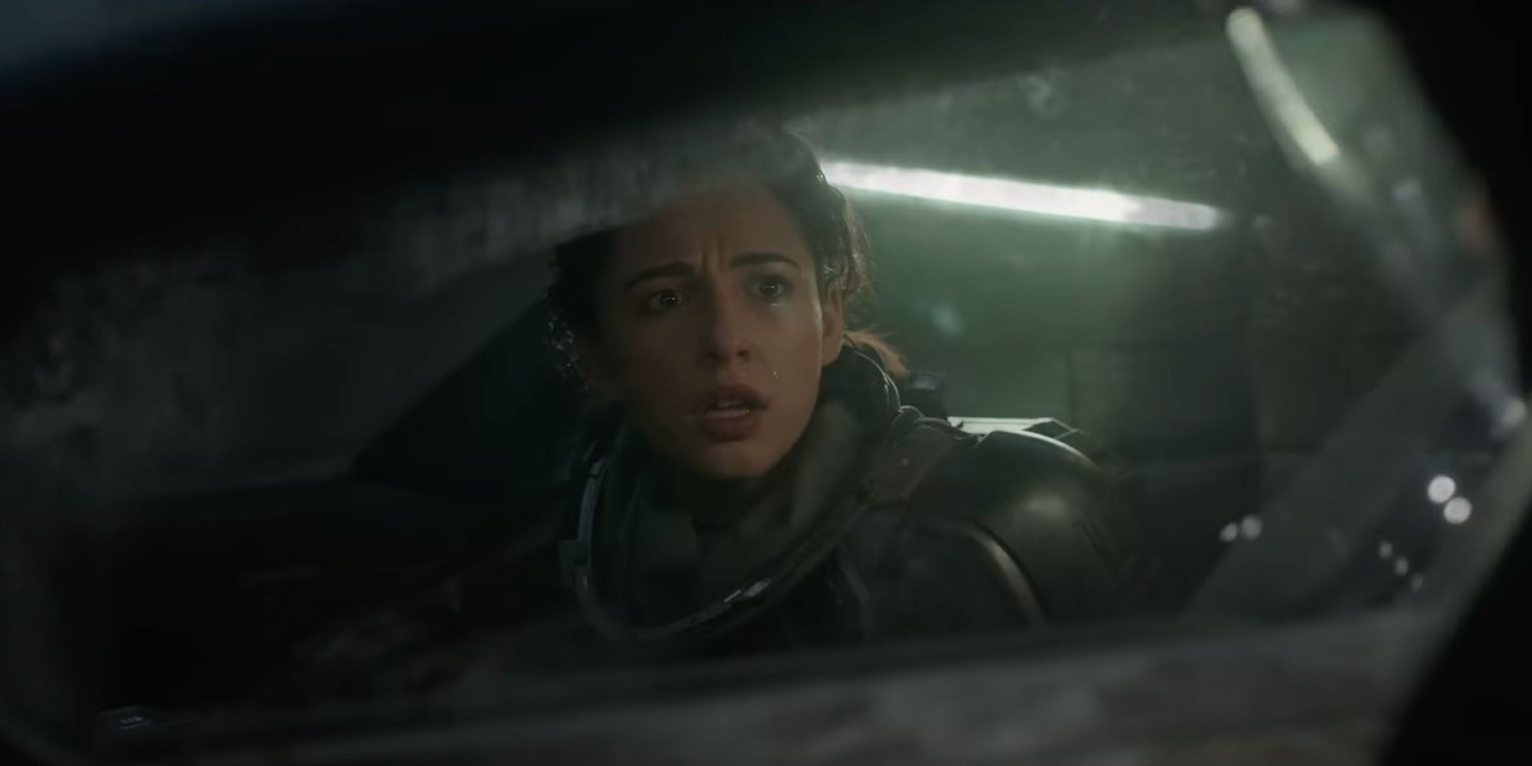 Naomi Scott looking worriedly through a ship window as Naomi in Long Distance