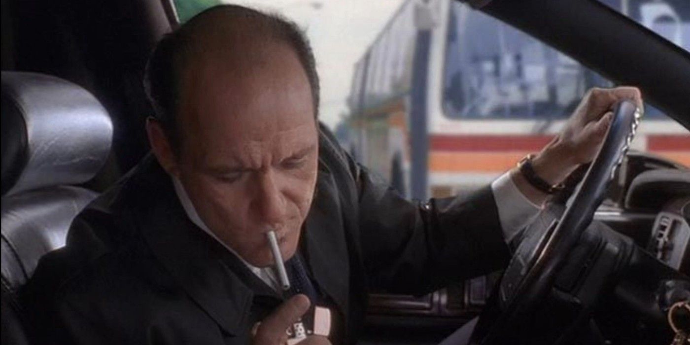 Nathaniel Fisher leaning over to light a cigarette while driving in Six Feet Under