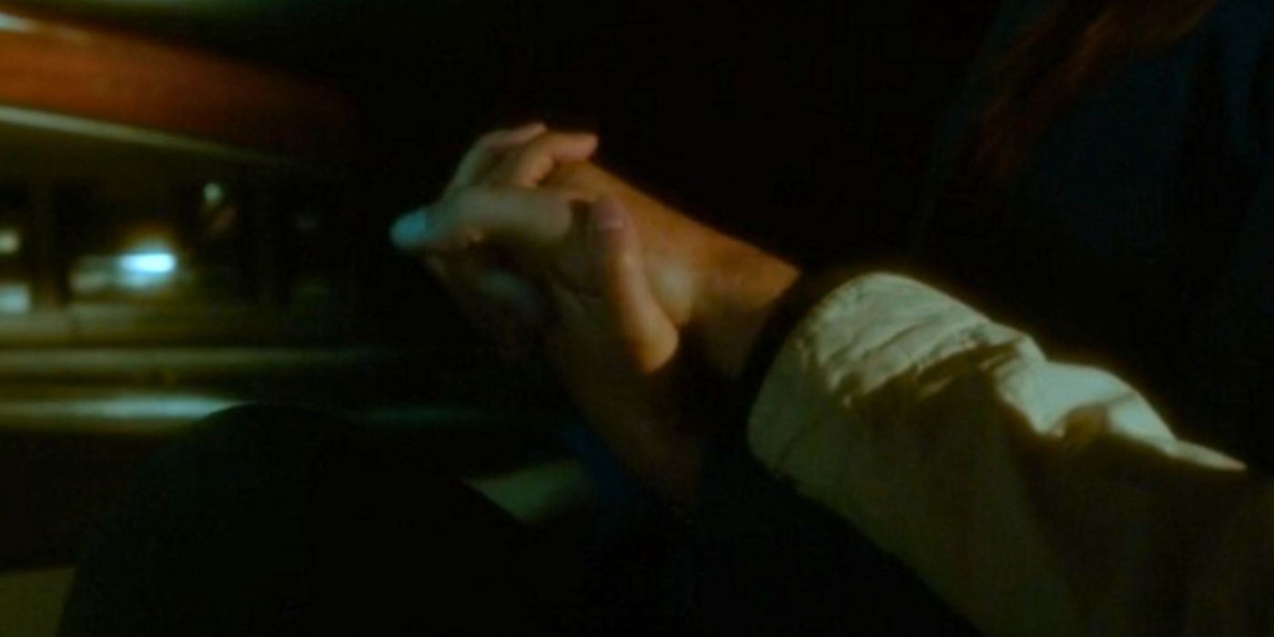 Tony and Ziva's clasped hands in their car in Berlin in NCIS