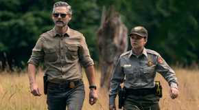 Eric Bana and a fellow officer walk in the wilderness in Untamed