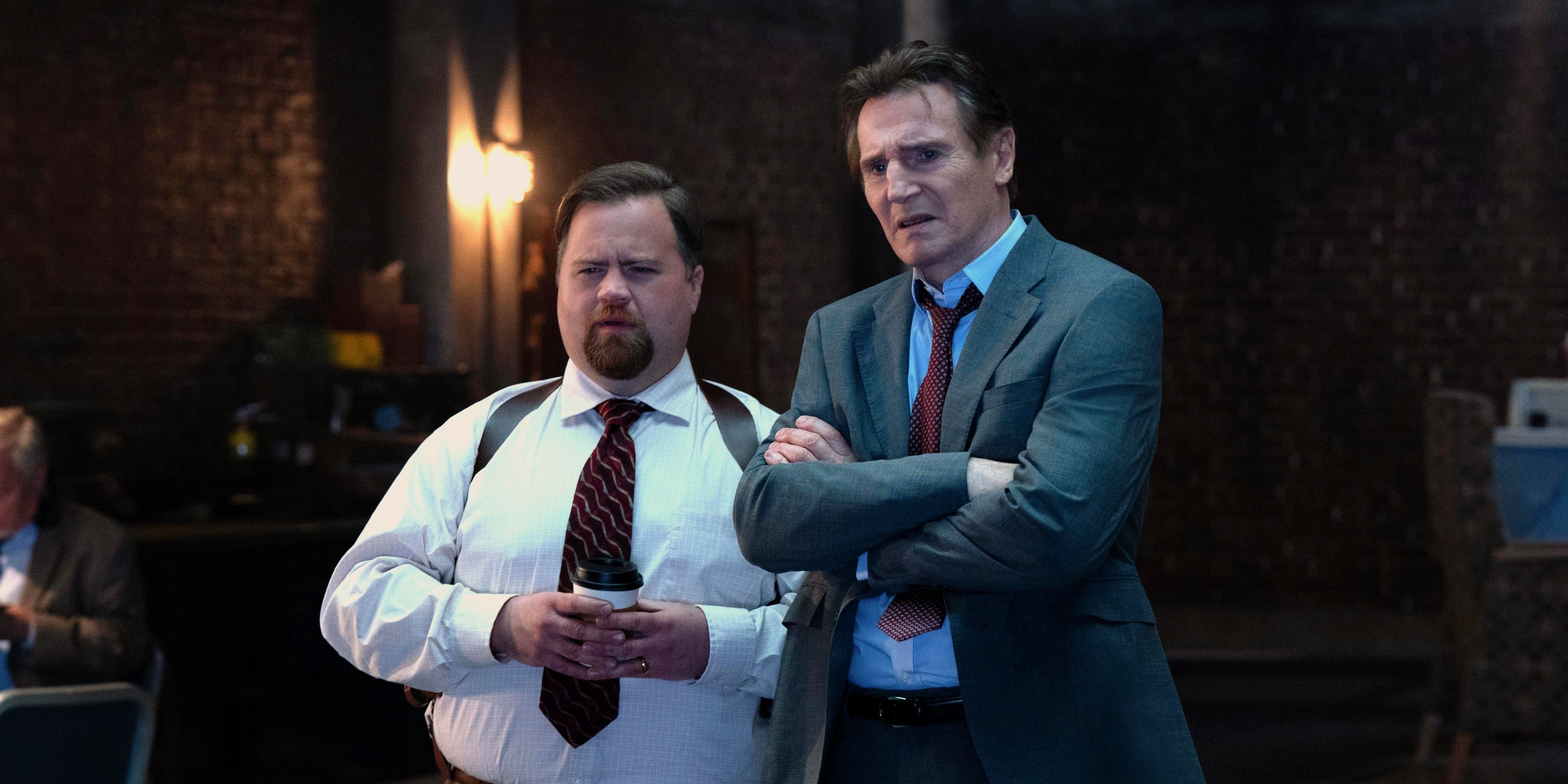 Paul Walter Hauser and Liam Neeson looking baffled at something in The Naked Gun