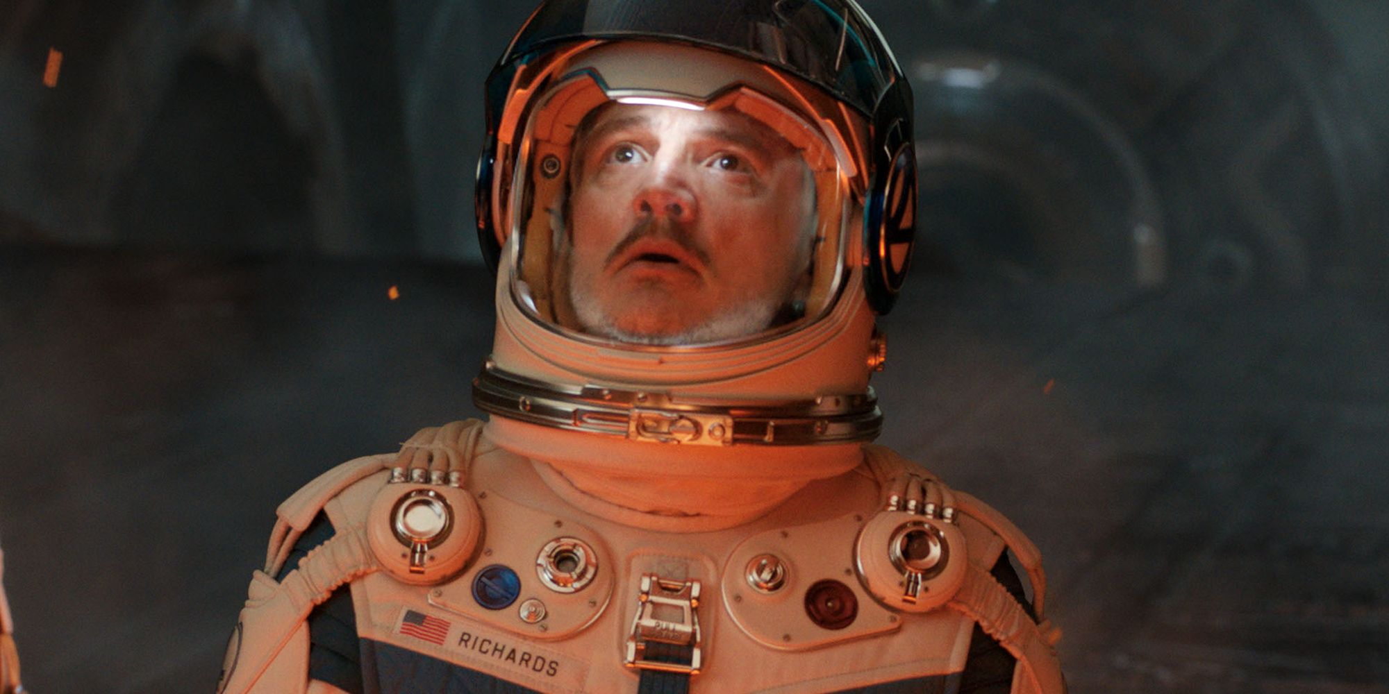 Pedro Pascal's Reed Richards looking scared in a space suit in The Fantastic Four: First Steps as he looks up