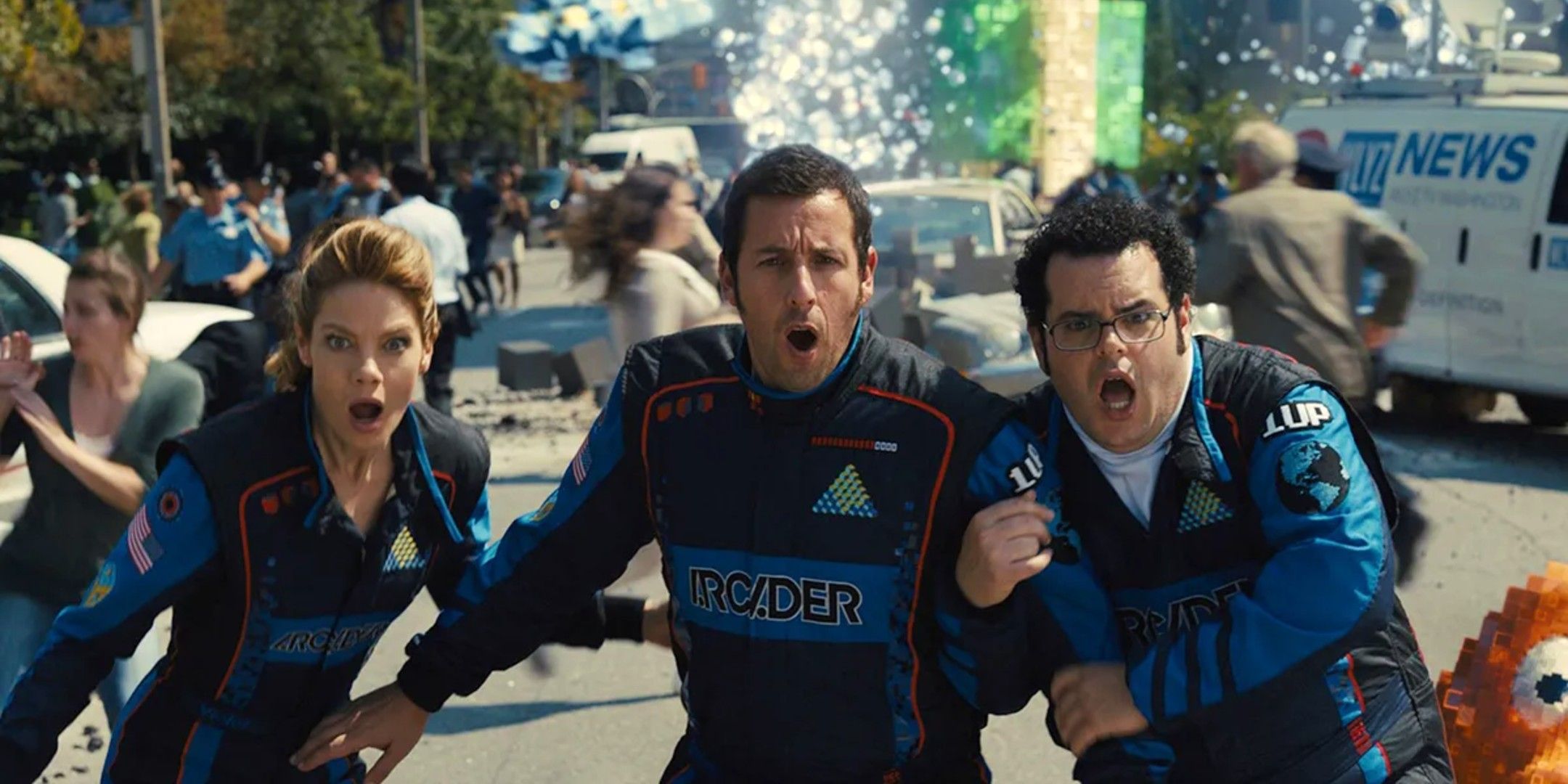 Adam Sandler, Josh Gad, and Michelle Monaghan hug each other in terror in Pixels