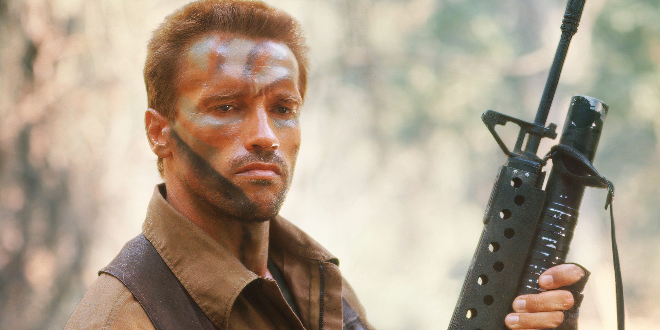 Arnold Schwarzenegger holding a rifle and looking serious as Dutch in Predator