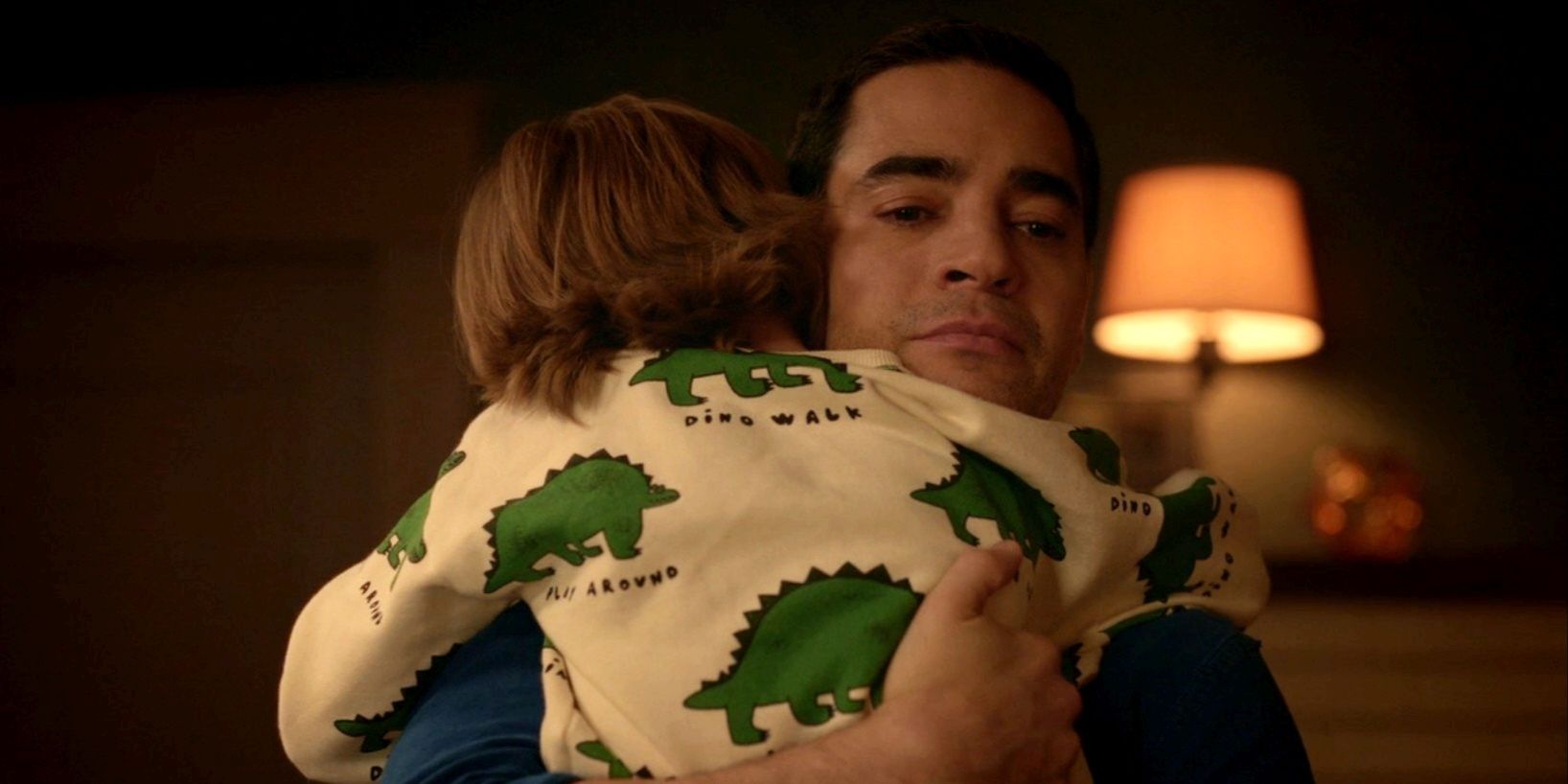 Ramon Rodriguez as Will Trent hugging a child in Will Trent season 1, episode 10